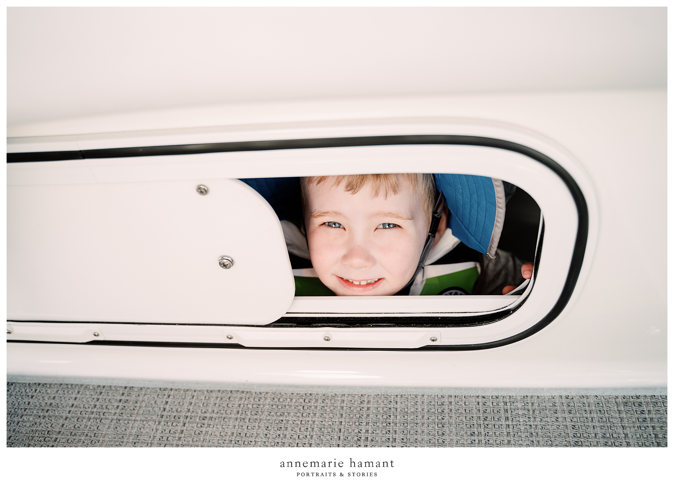 Child peeks through porthole on boat ride.  