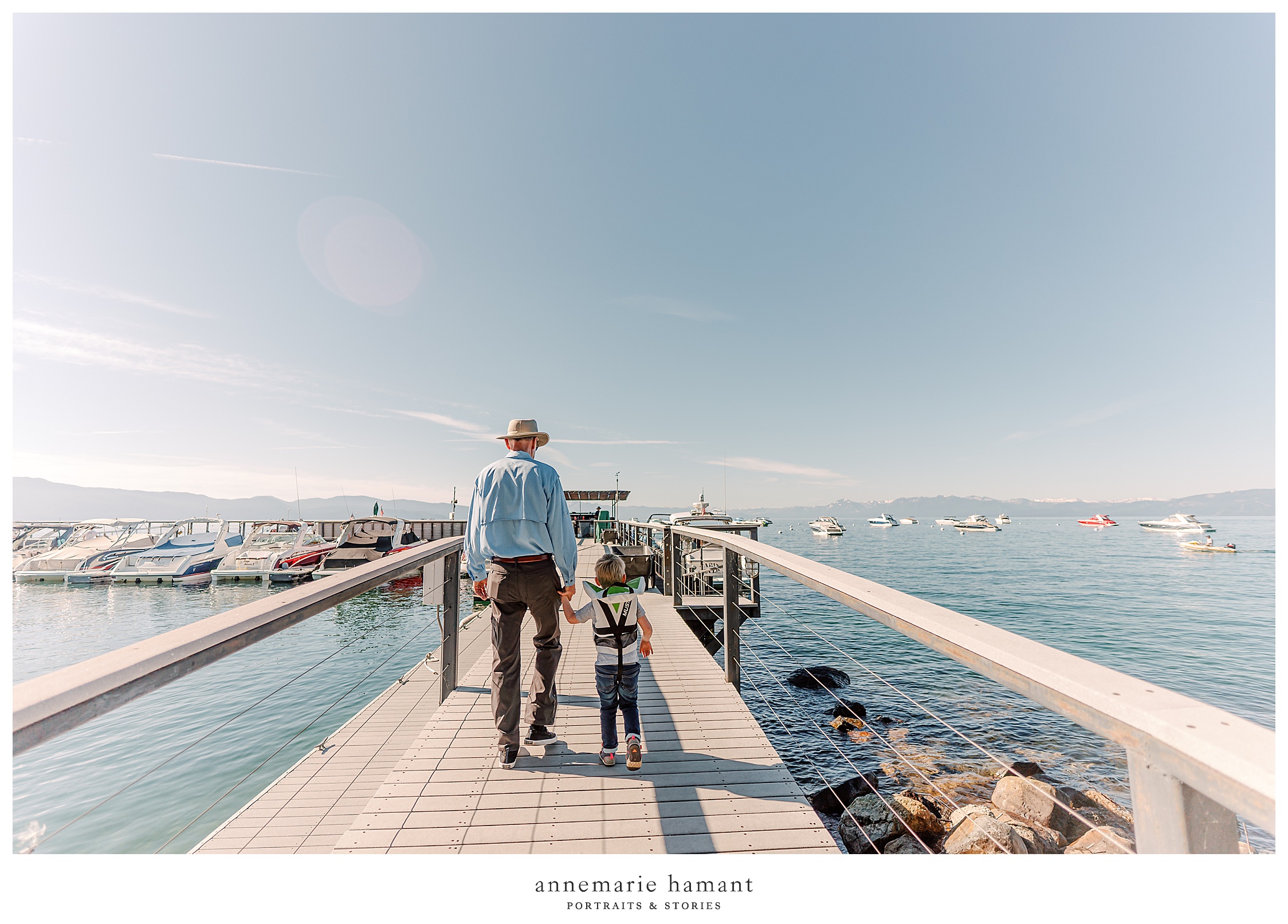  Grandfather and grandson walk the pier on Lake Tahoe.  