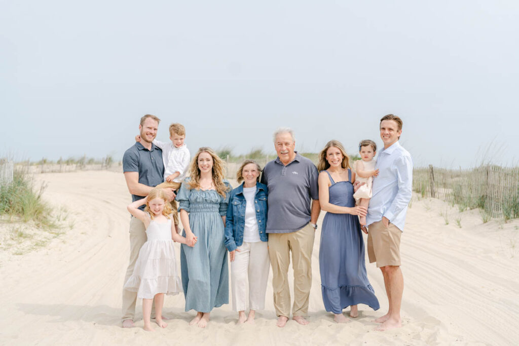 Large family poses for a picture on the beach 