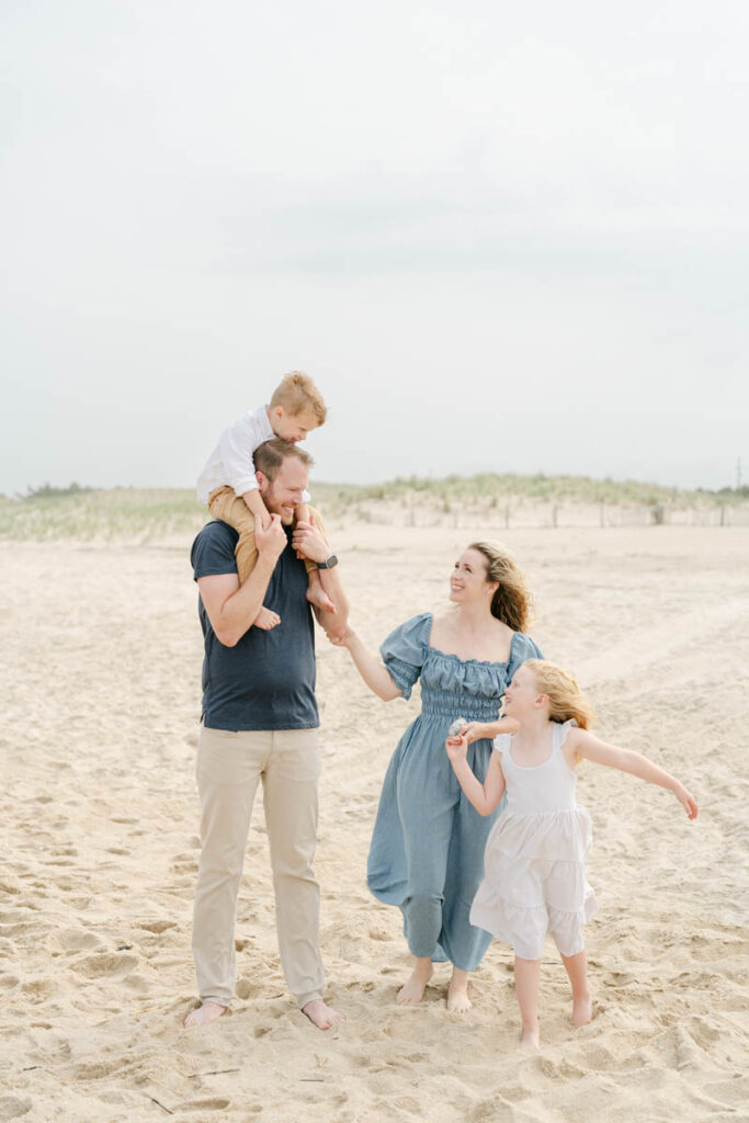 Family of four plays on the beach near Bethany Beach DE