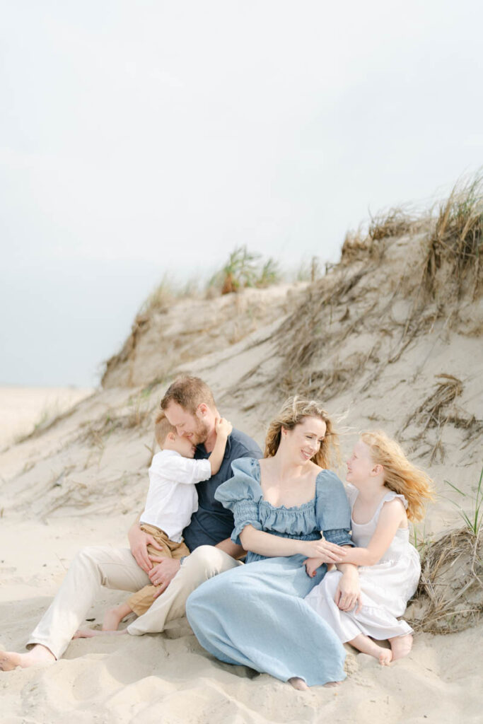 Family of four poses for a photo session with Bethany Beach Photographer AnneMarie Hamant