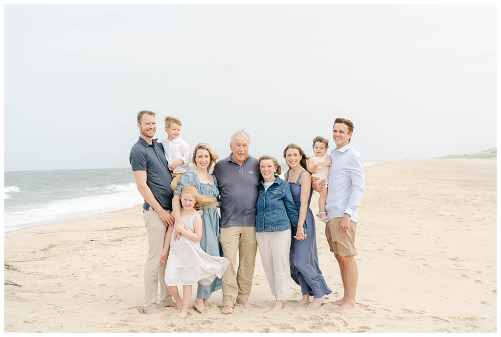 Large family poses for picture on the beach in delaware