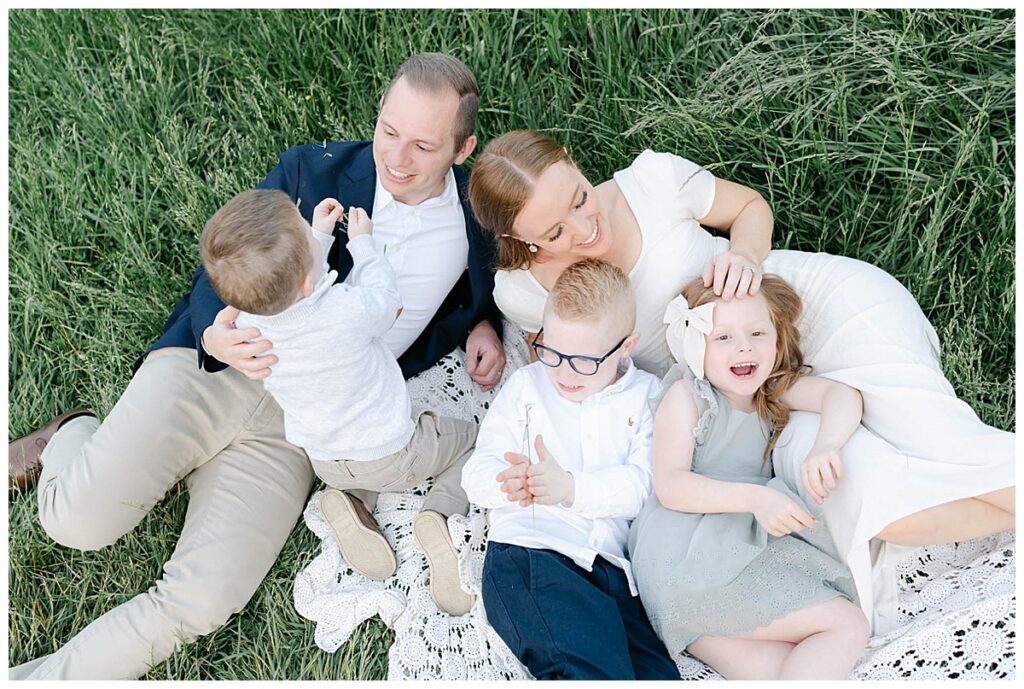 Family of five lays in grass during a photo session