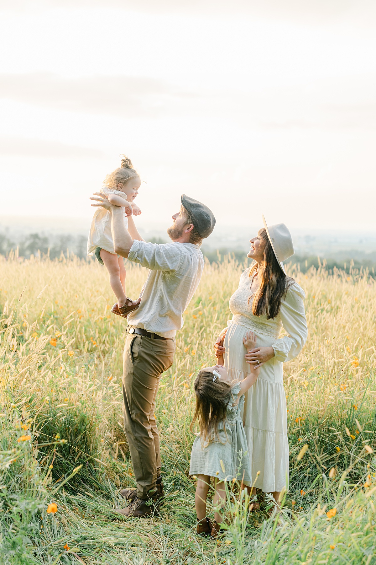 maternity session with family in wildflower field playing by Philadelphia Maternity Photographer, AnneMarie Hamant
