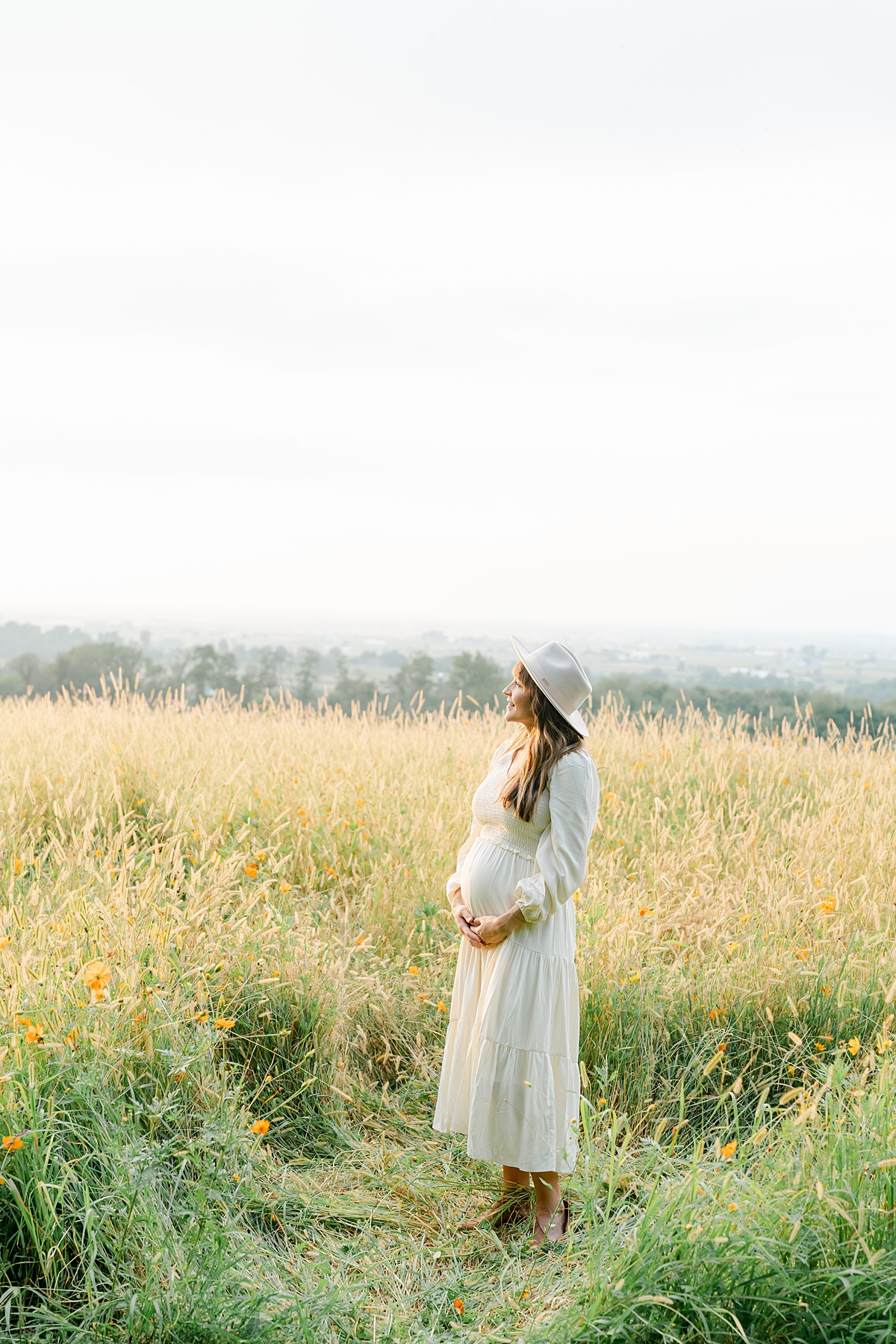 expecting mother in wildflower field by Philadelphia Maternity Photographer, AnneMarie Hamant