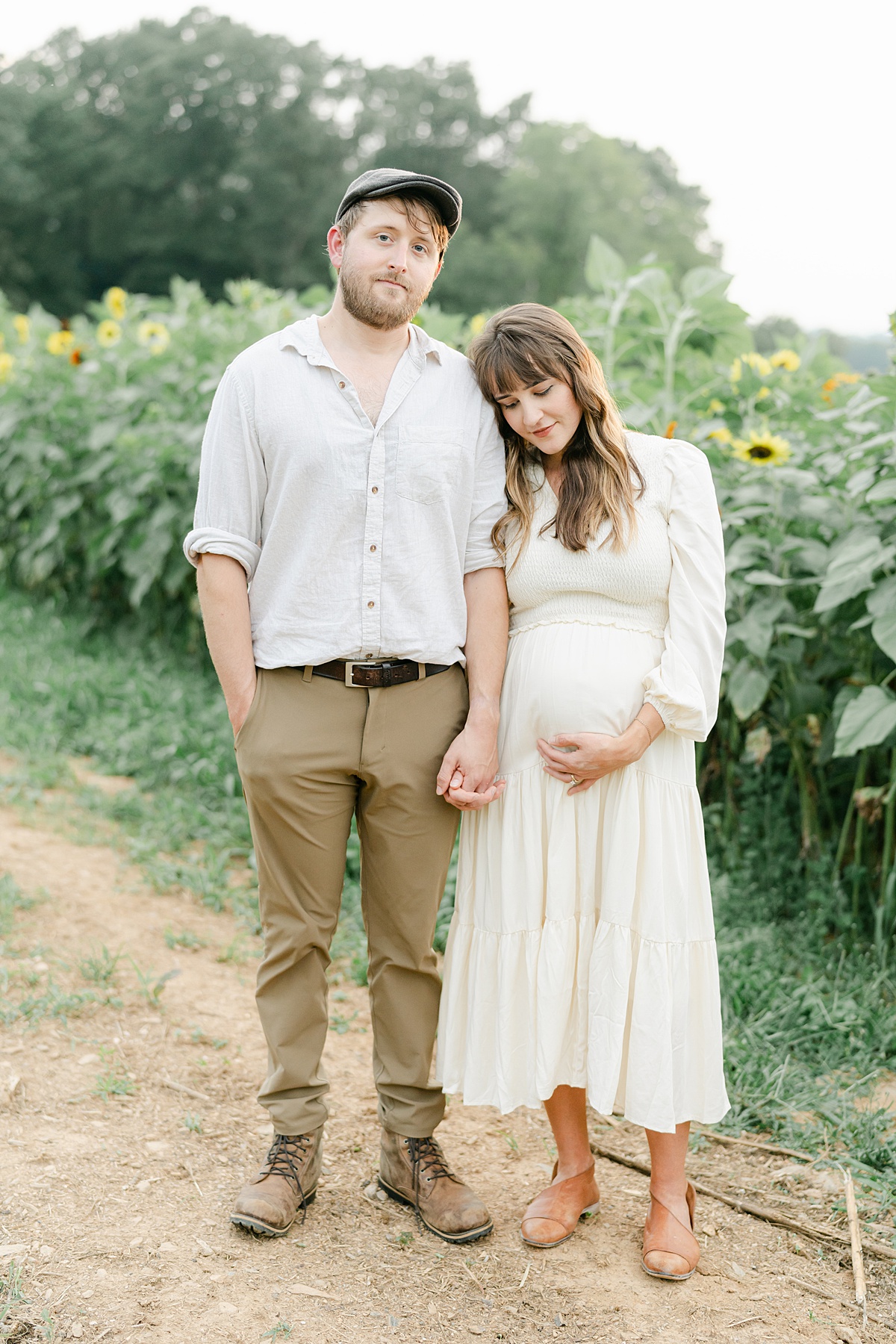 husband and wife in sunflowers by Philadelphia Maternity Photographer, AnneMarie Hamant