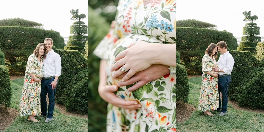 expecting parents snuggled together in a shrub garden holding their hands on moms belly