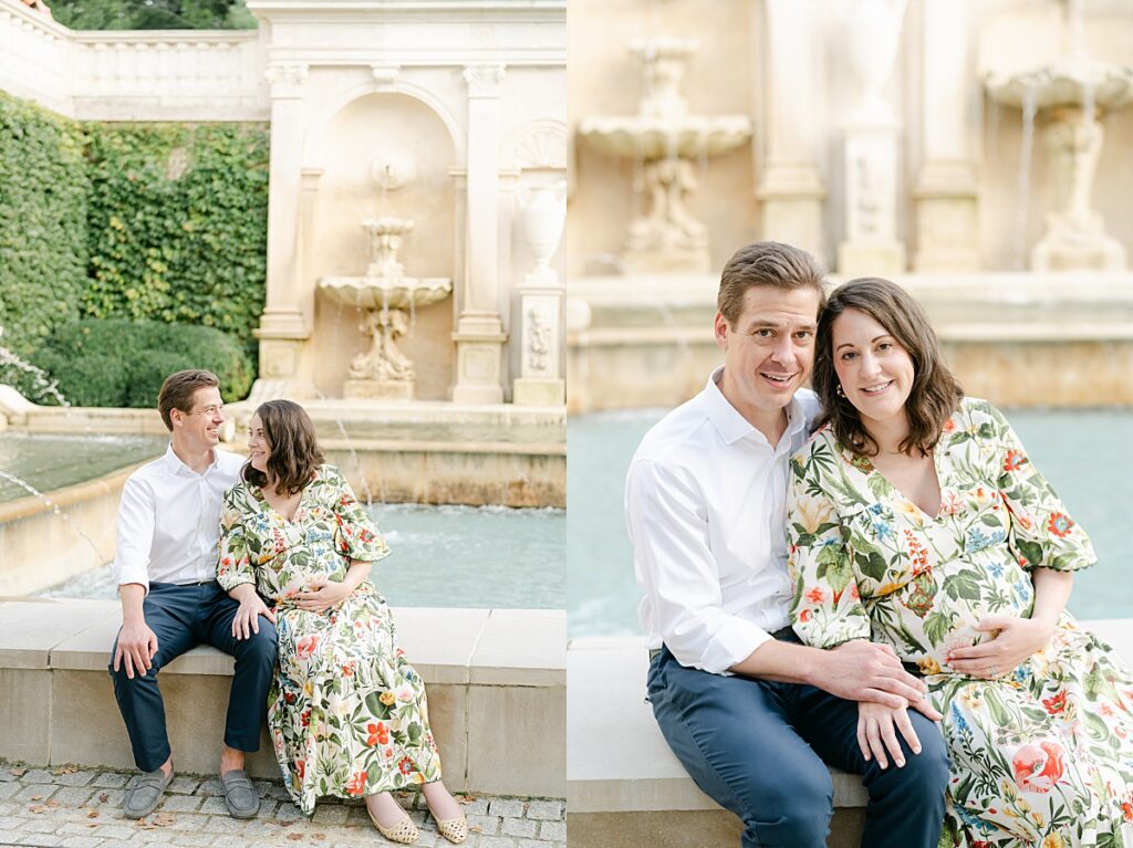 pregnant mom and dad sitting on a fountain ledge while snuggled together
