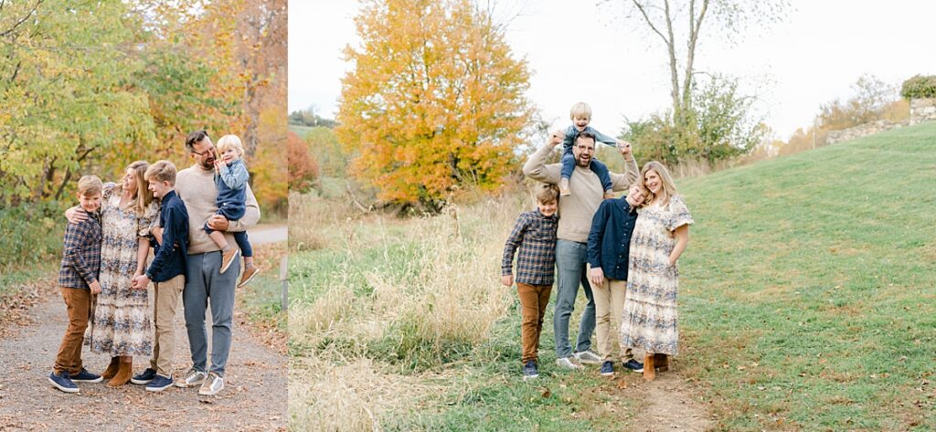 A family of five standing on a grassy hill in front of fall foliage while huddled close together