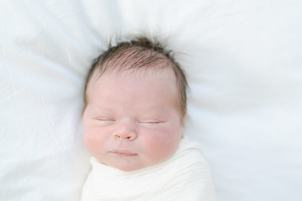 Newborn boy swaddled in white swaddle by Philly Newborn Photographer, AnneMarie Hamant
