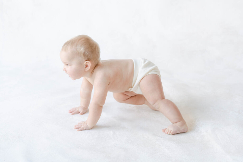 baby learning to crawl in a Philadelphia baby photography studio