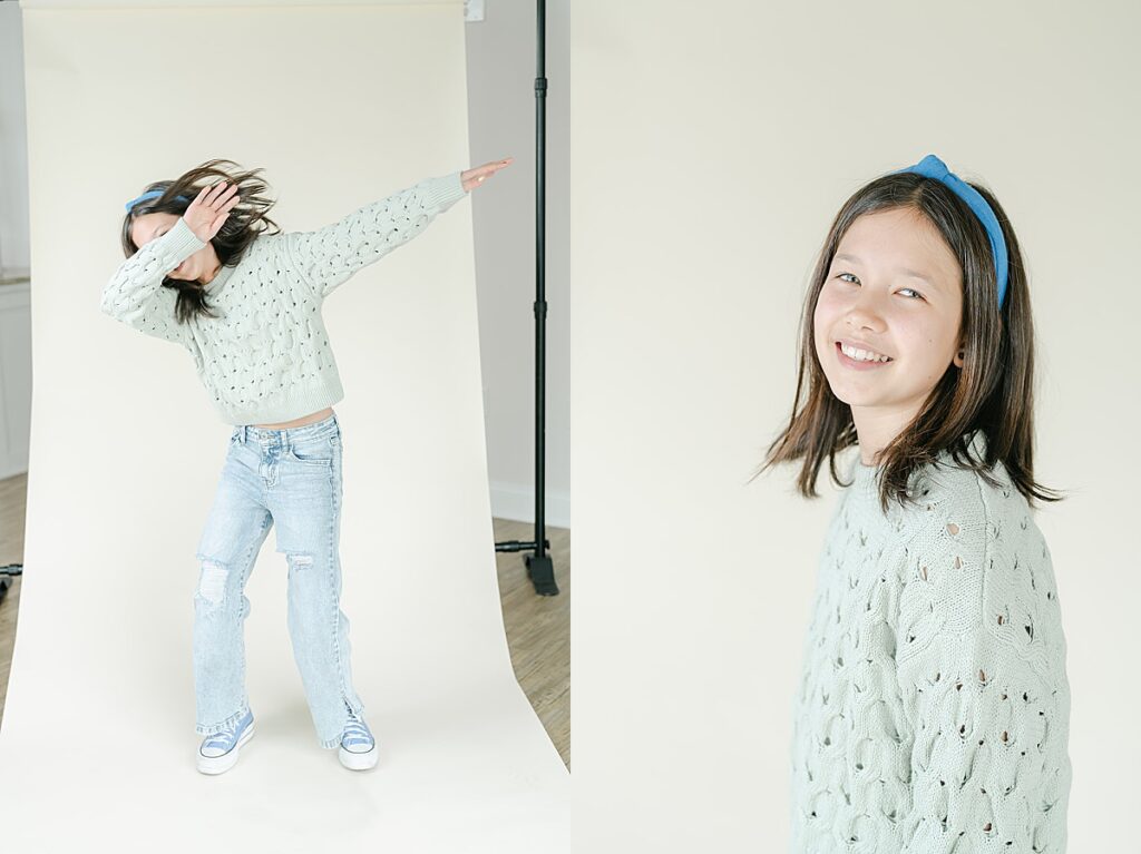 Older girl dancing and smiling at the camera in front of a beige backdrop.