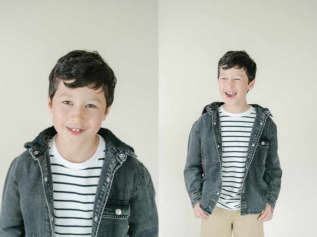 Older boy in a striped shirt and denim jacket smiling and laughing at the camera in front of a beige backdrop.