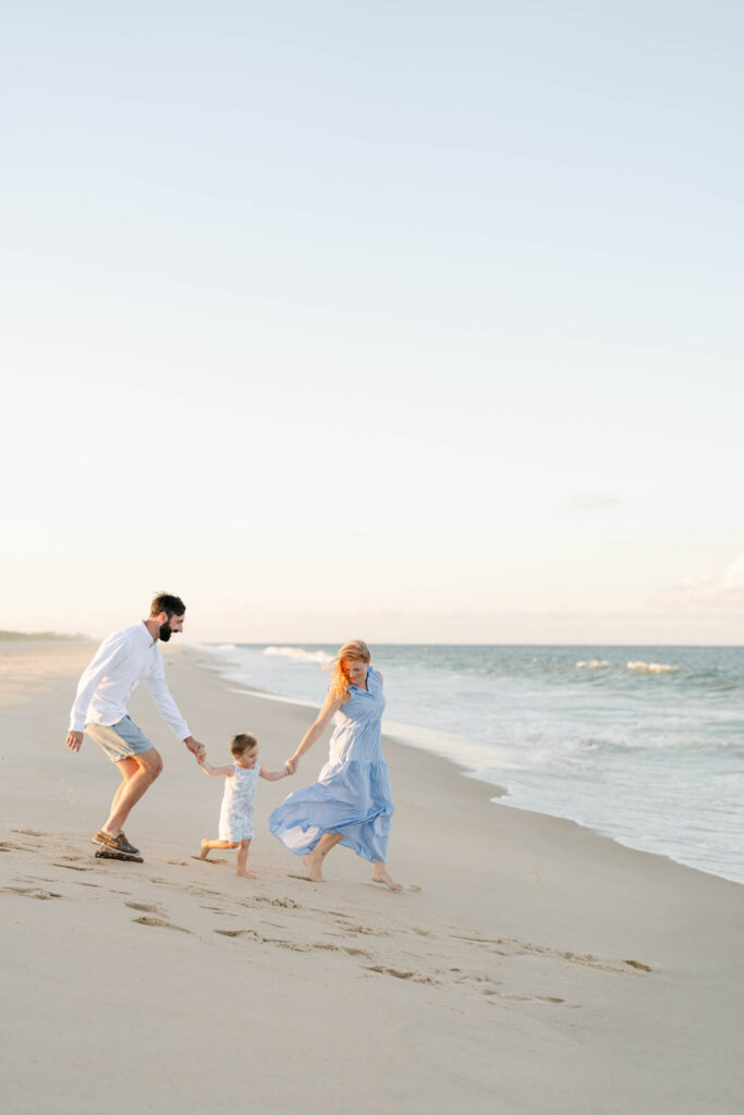 Family runs towards the water in Bethany Beach