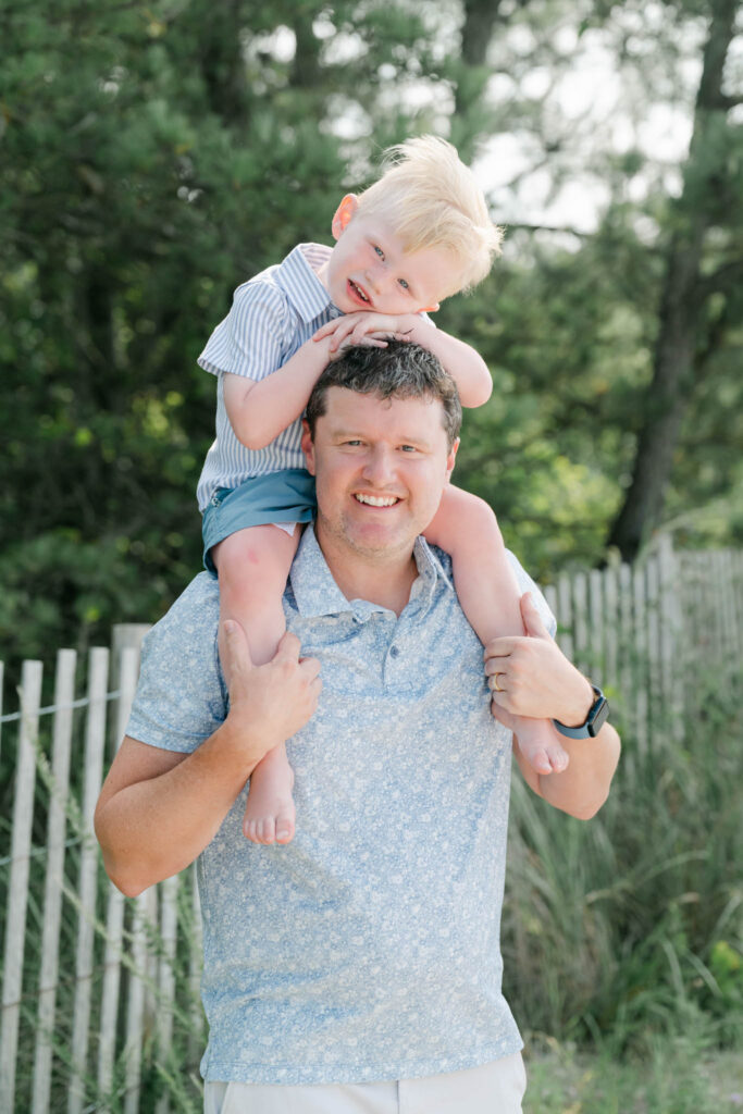 Dad holds toddler son at BEthany Beach photo session