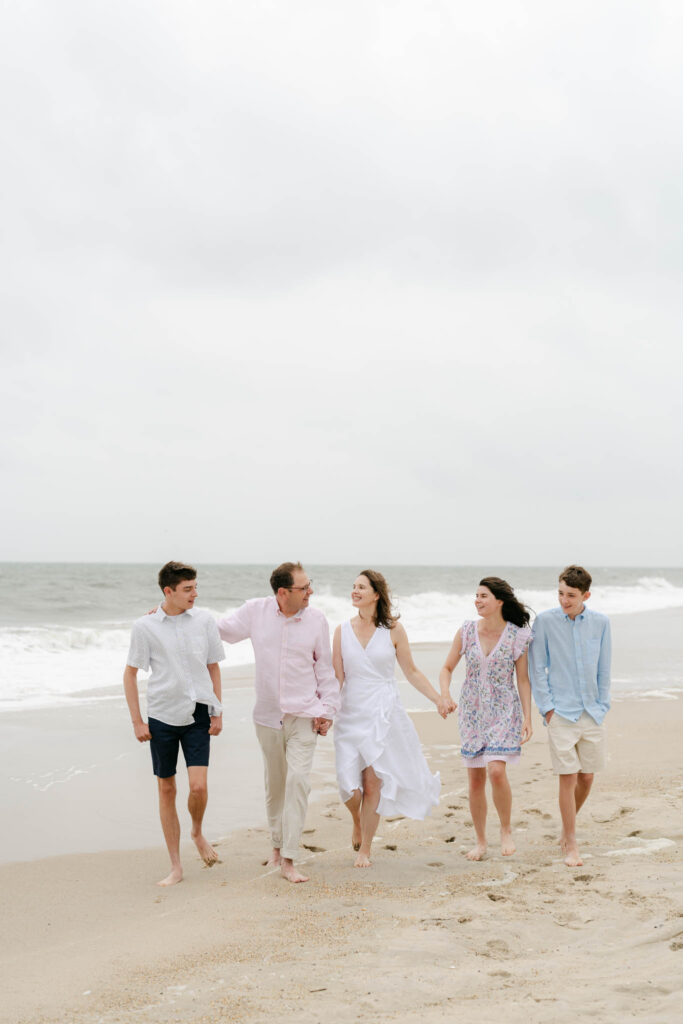 family with teens walks Bethany Beach
