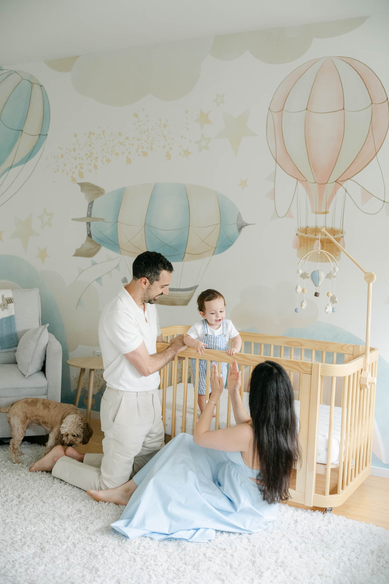 Philadelphia couple plays with older baby in crib